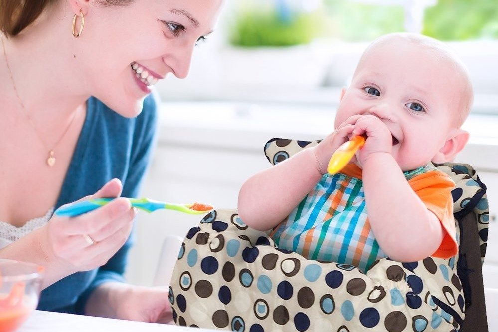 baby in high chair next to mom