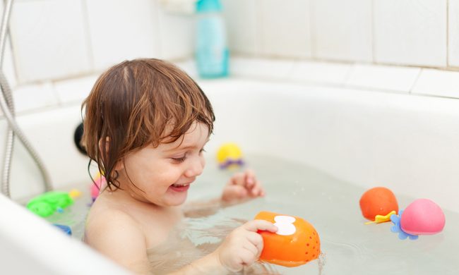 A child playing in the bath.