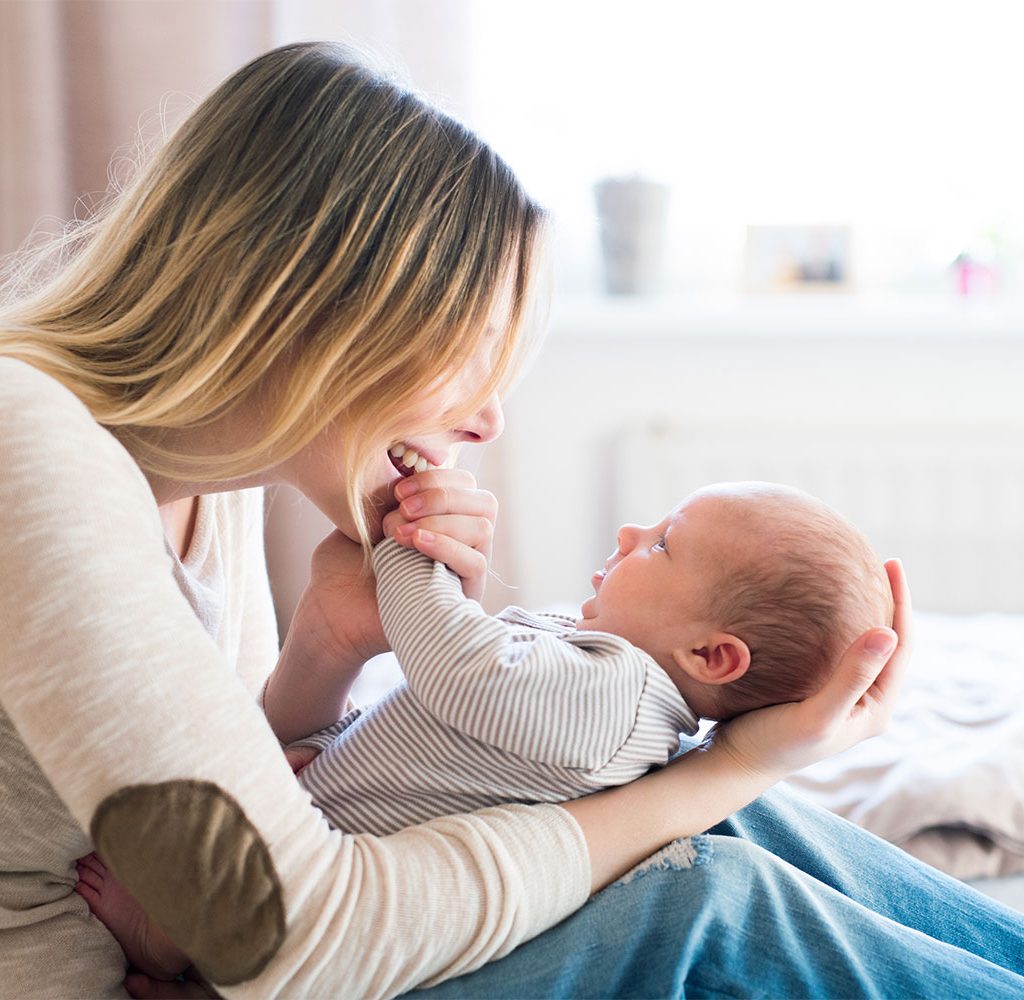 maternity jeans holding newborn