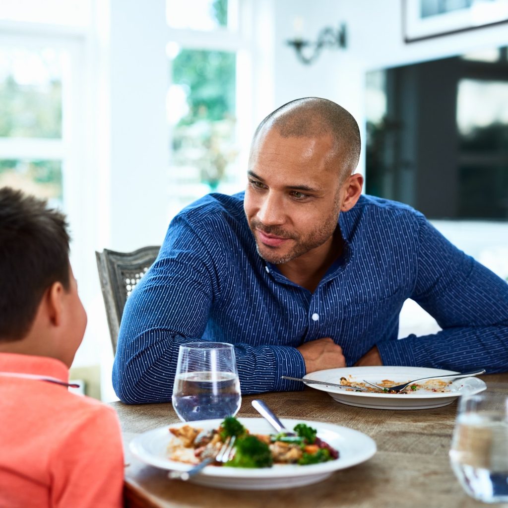 Father and son sitting at table