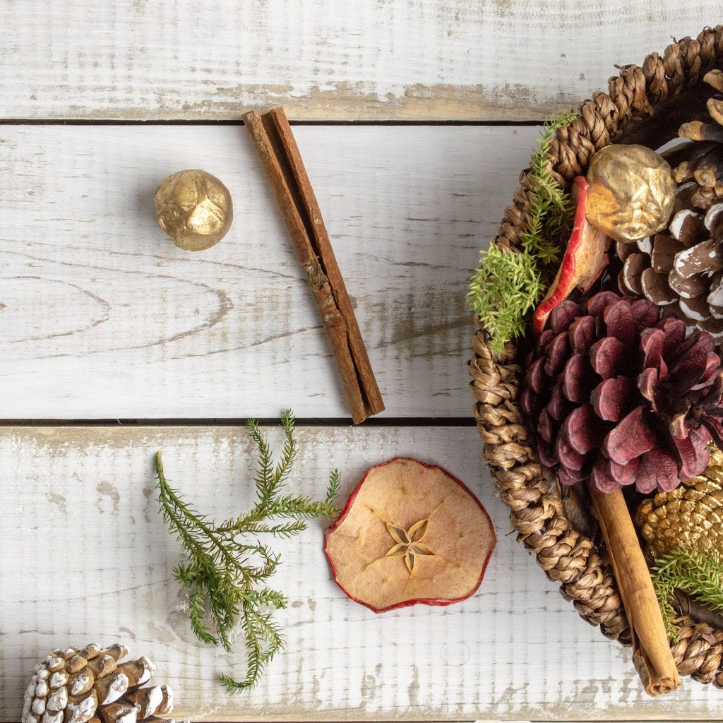 basket with natural elements like dried fruit and pinecones