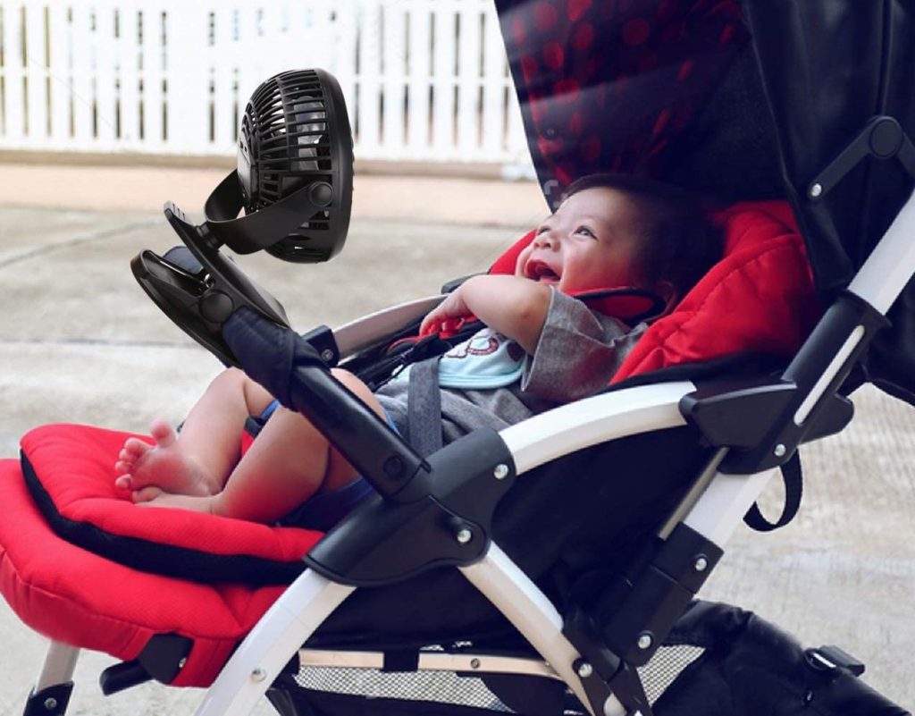 Baby lying in stroller smiling