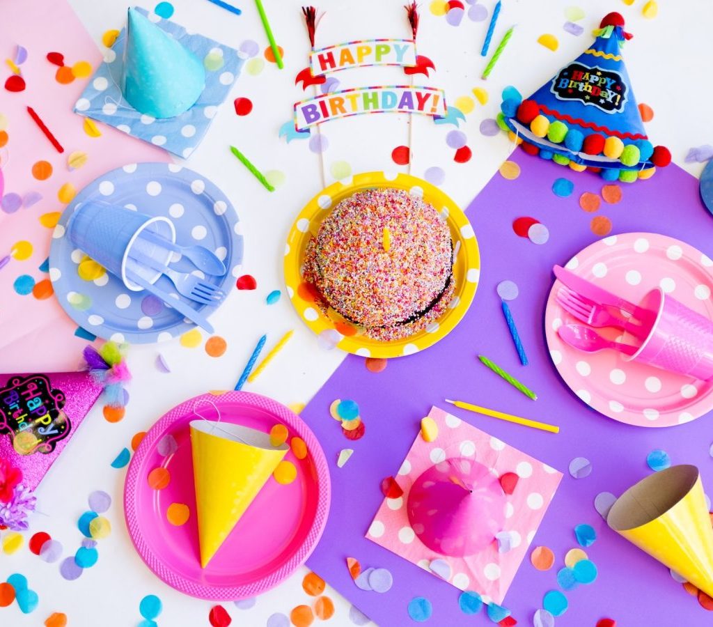 Colorful birthday party table with plates and food