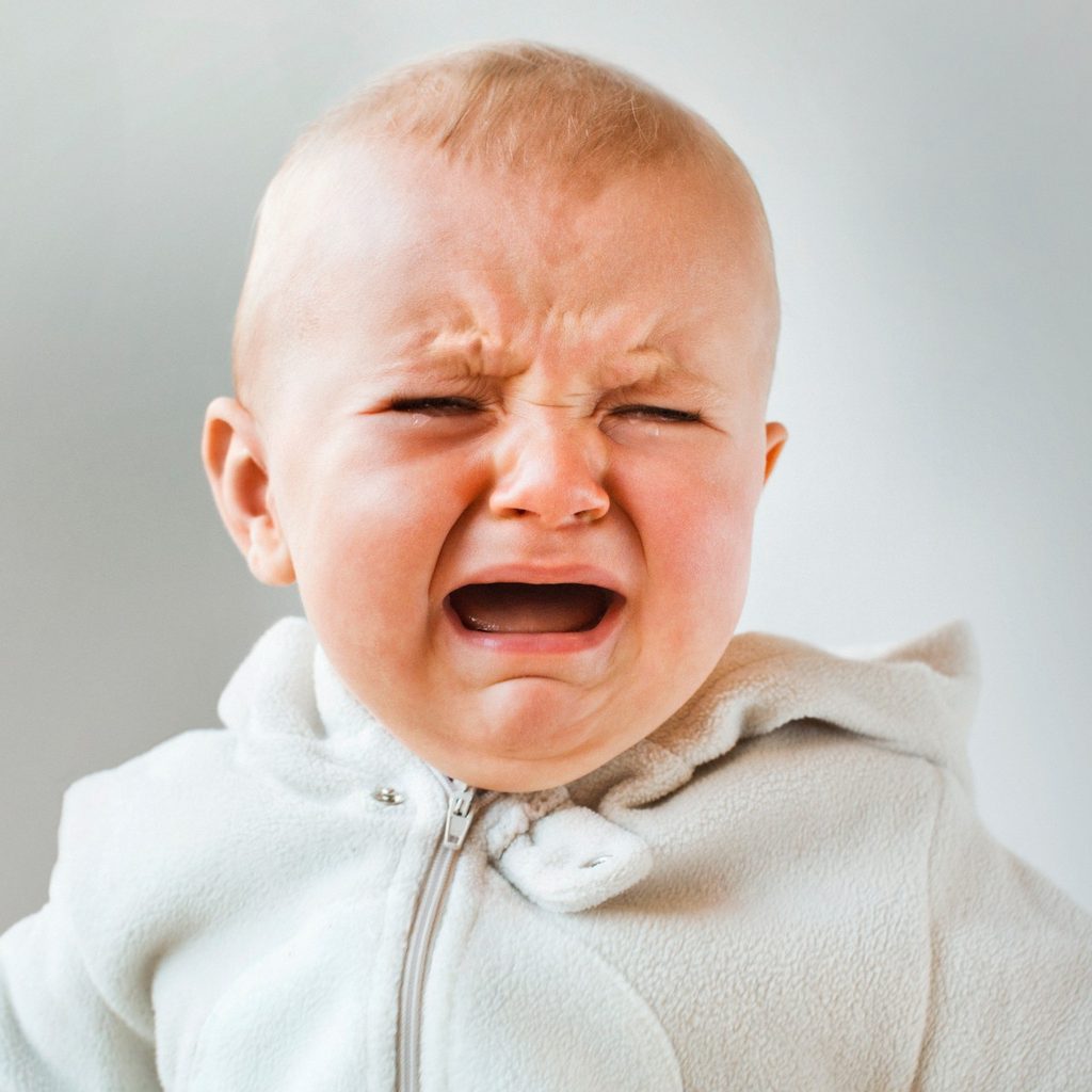 Crying baby in onesie