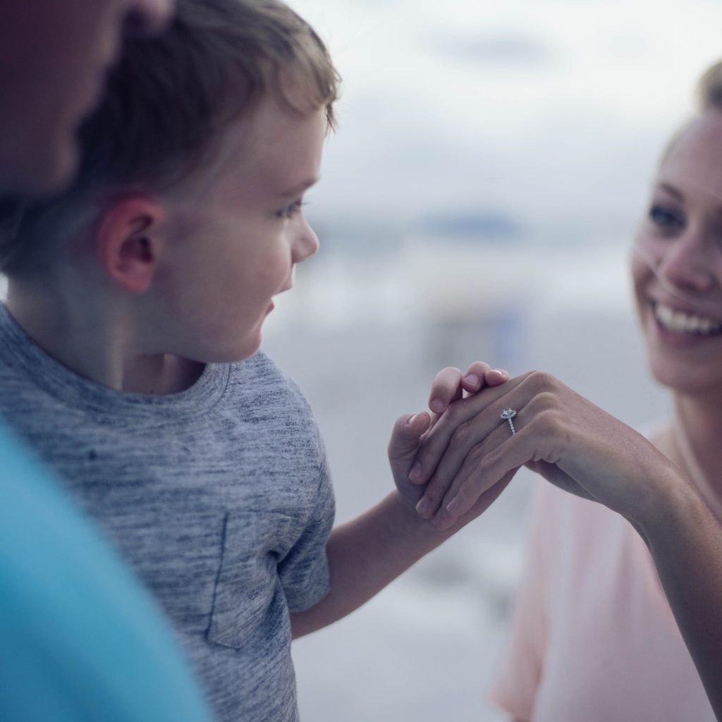 Mother holding her son's hand