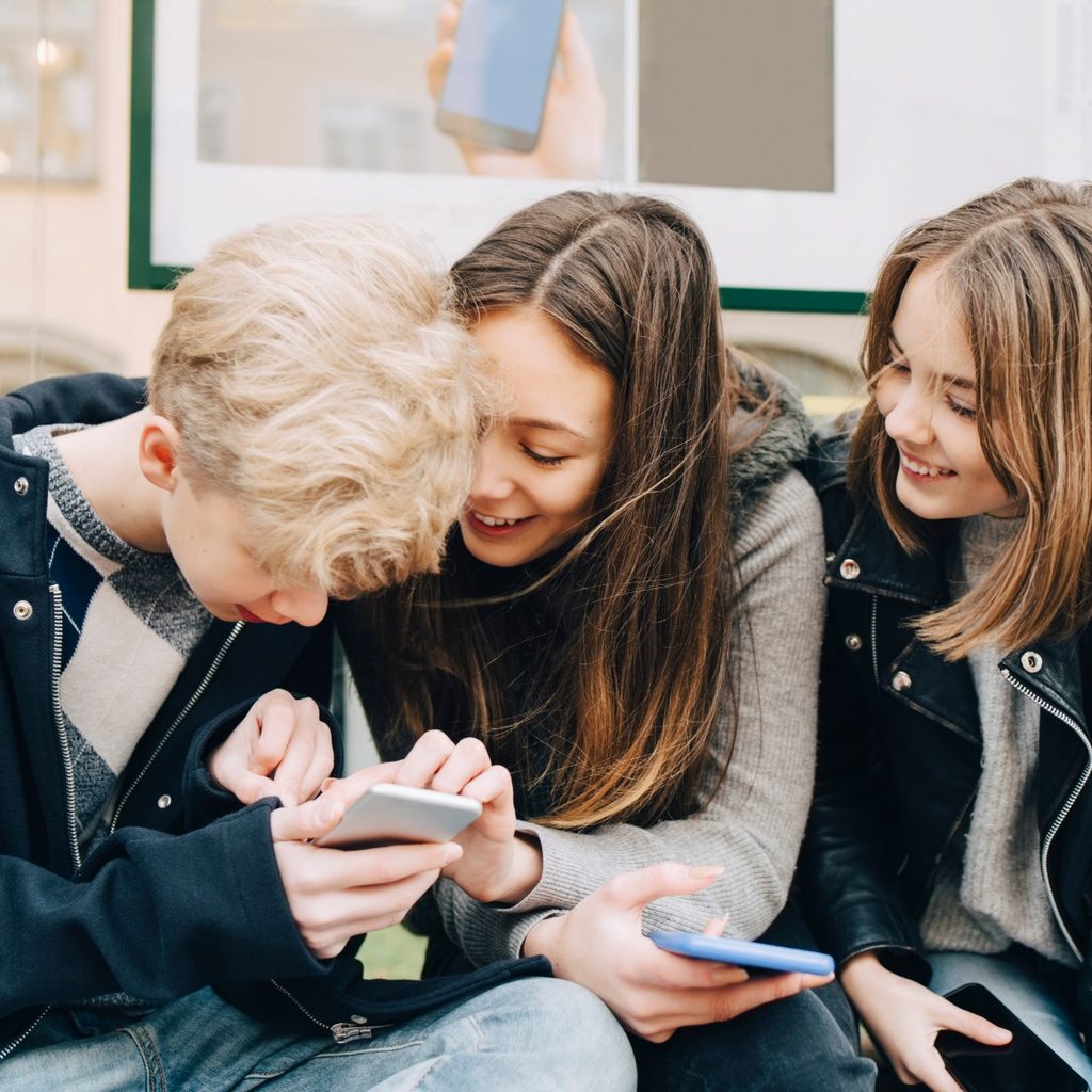 Teenagers looking at a smartphone