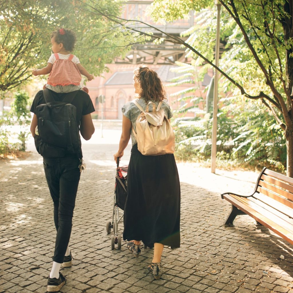 Parents with a child and a bag