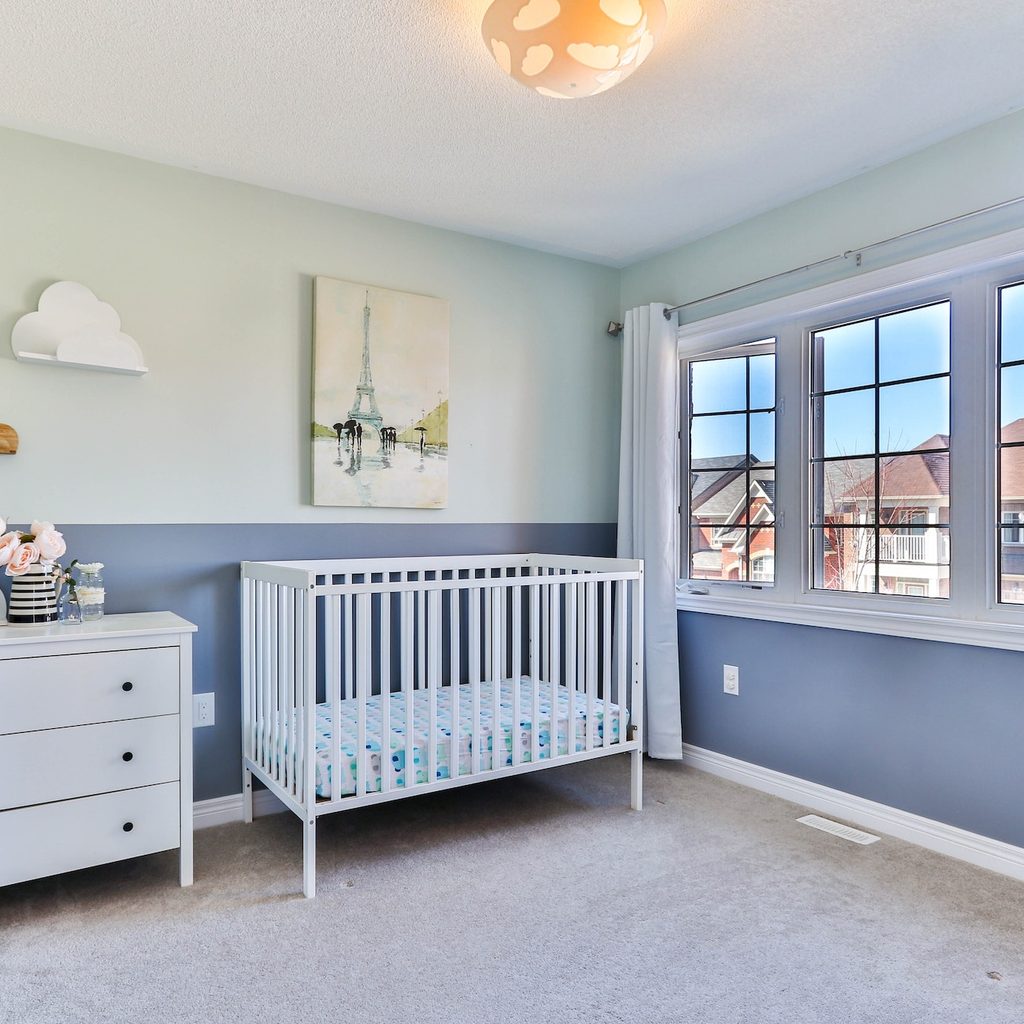 minimalist nursery with gray-blue walls and a window