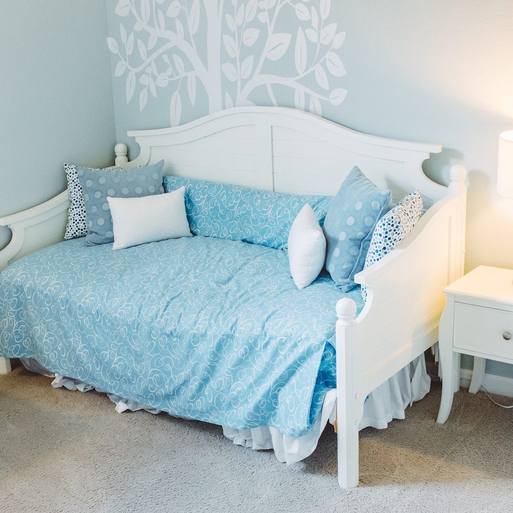blue and white nursery with bright blue sheets
