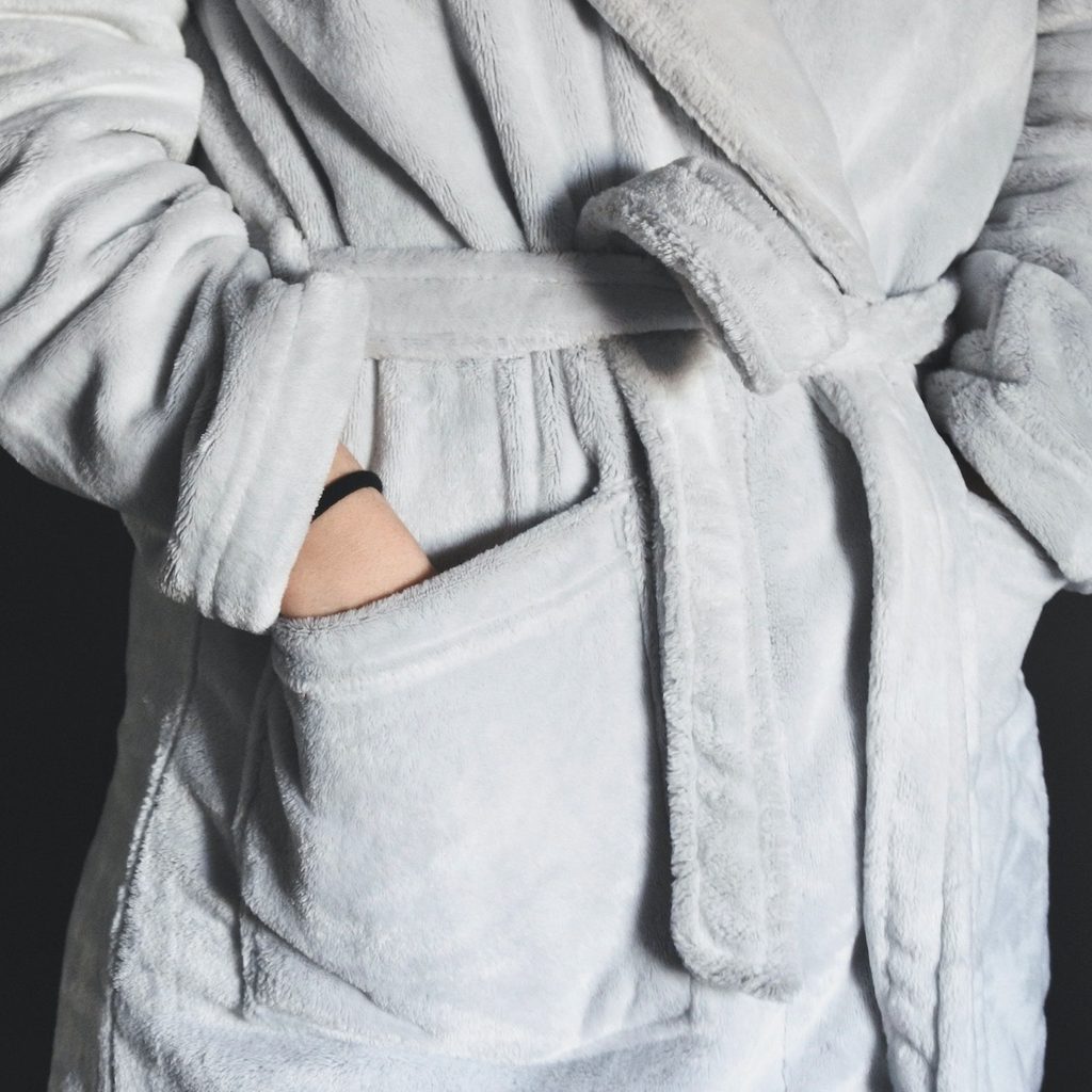 person wearing grab robe with hands in the pockets