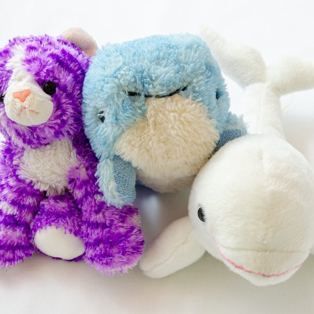 three stuffed animals next to each other