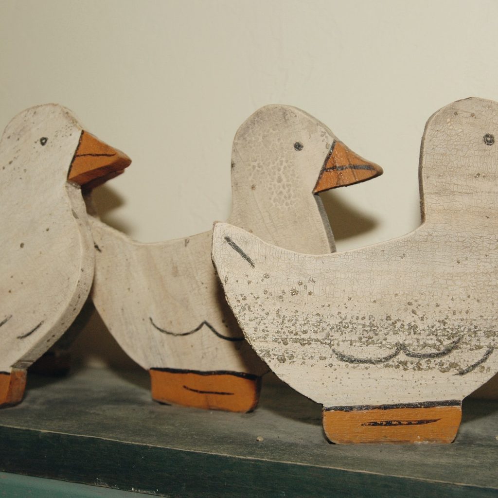 three flat wooden ducks