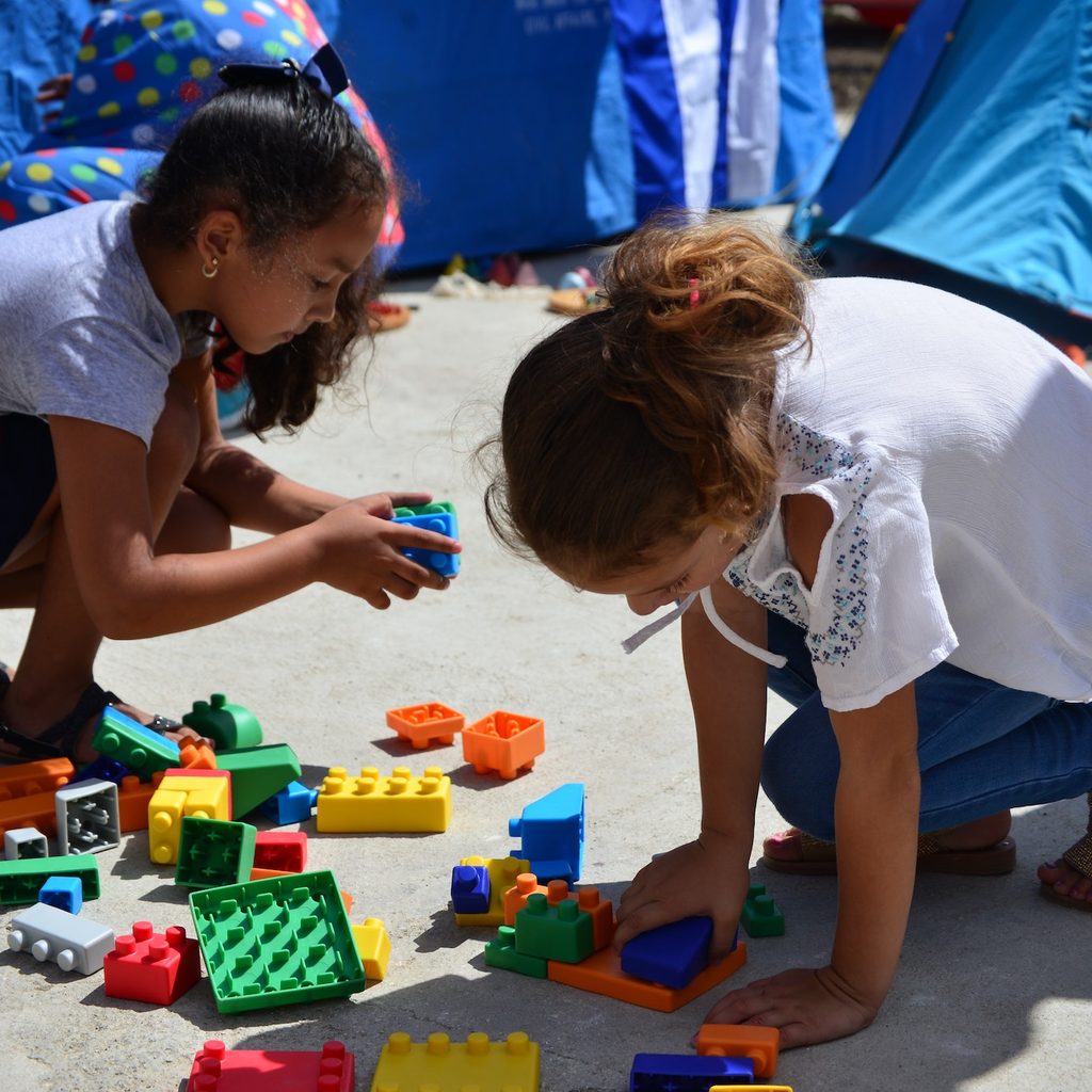 two girls playing with Legos