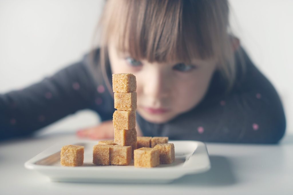 Child with plate of sugary treats