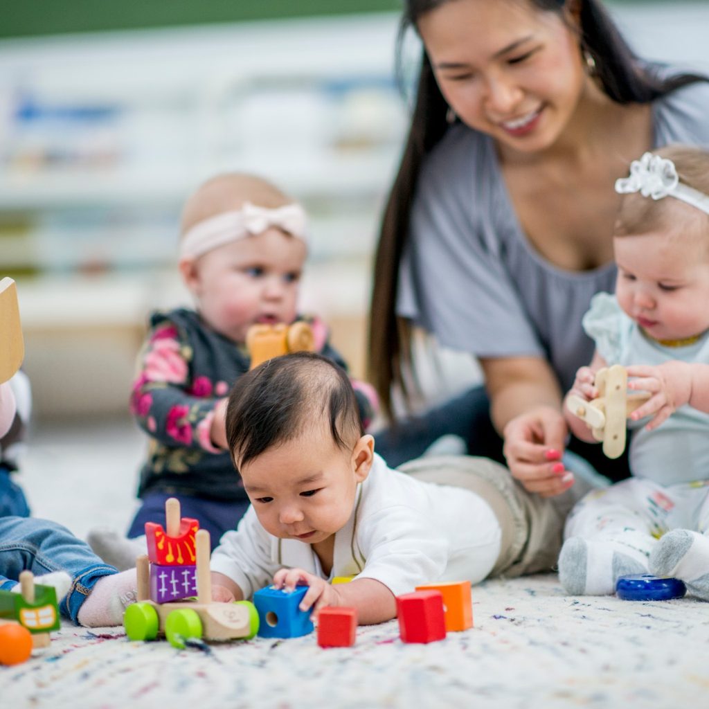 Woman working at day care with children