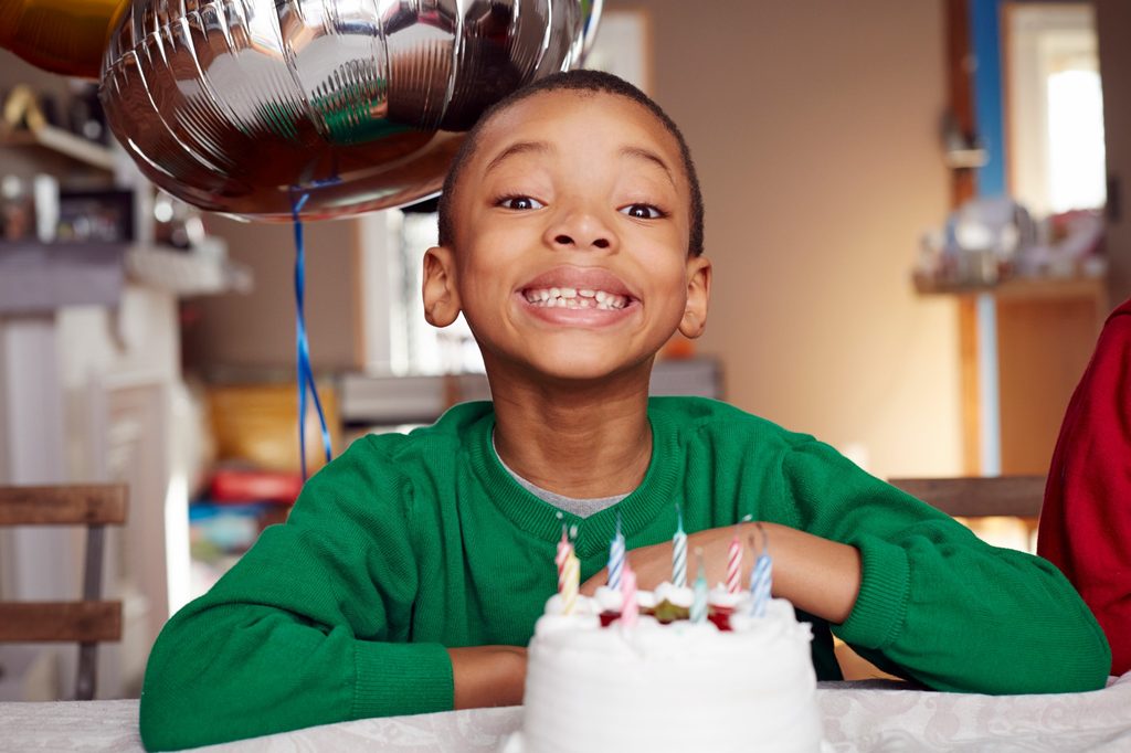 Smiling child with birthday cake