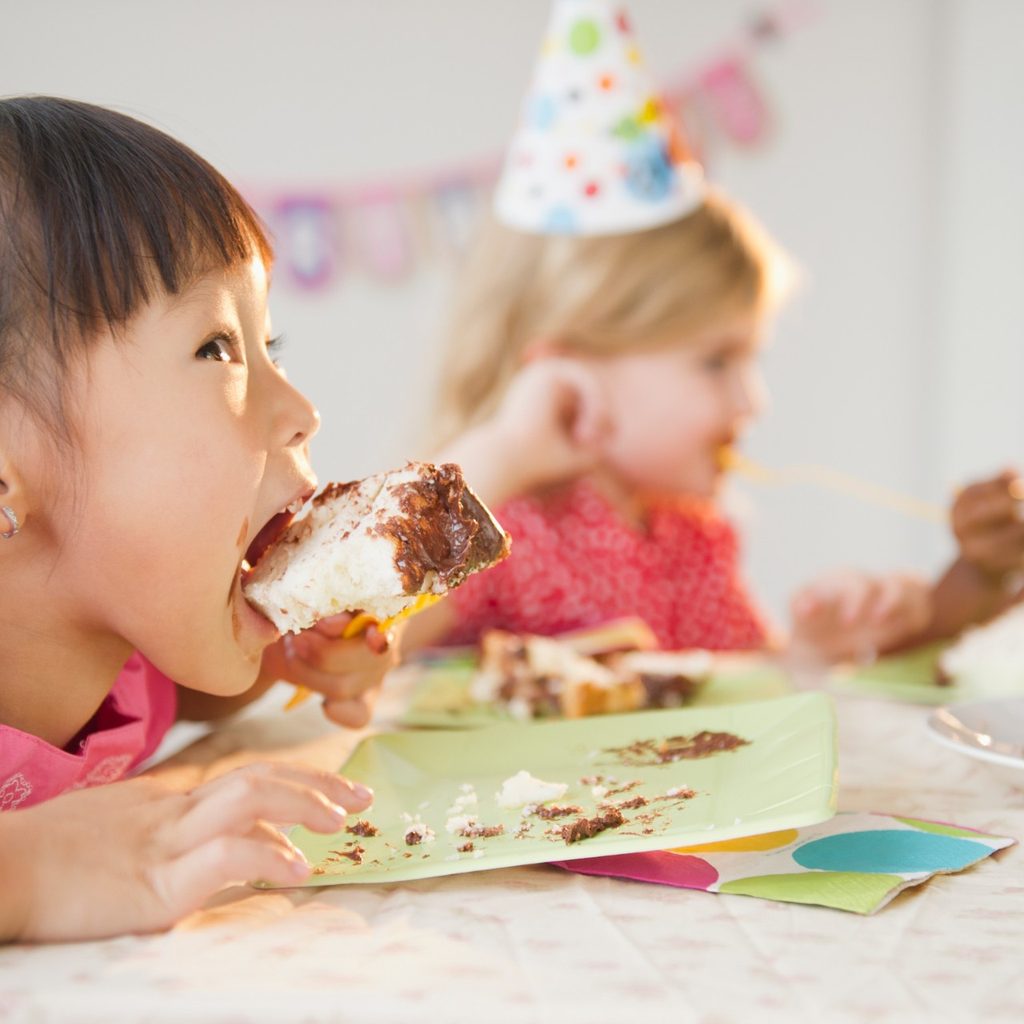 Child eating cake at a birthday party