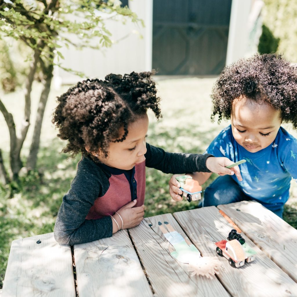 Two toddlers playing outside