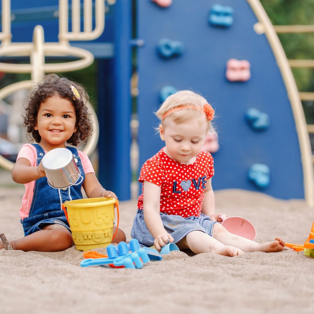 Two toddlers playing at a playground