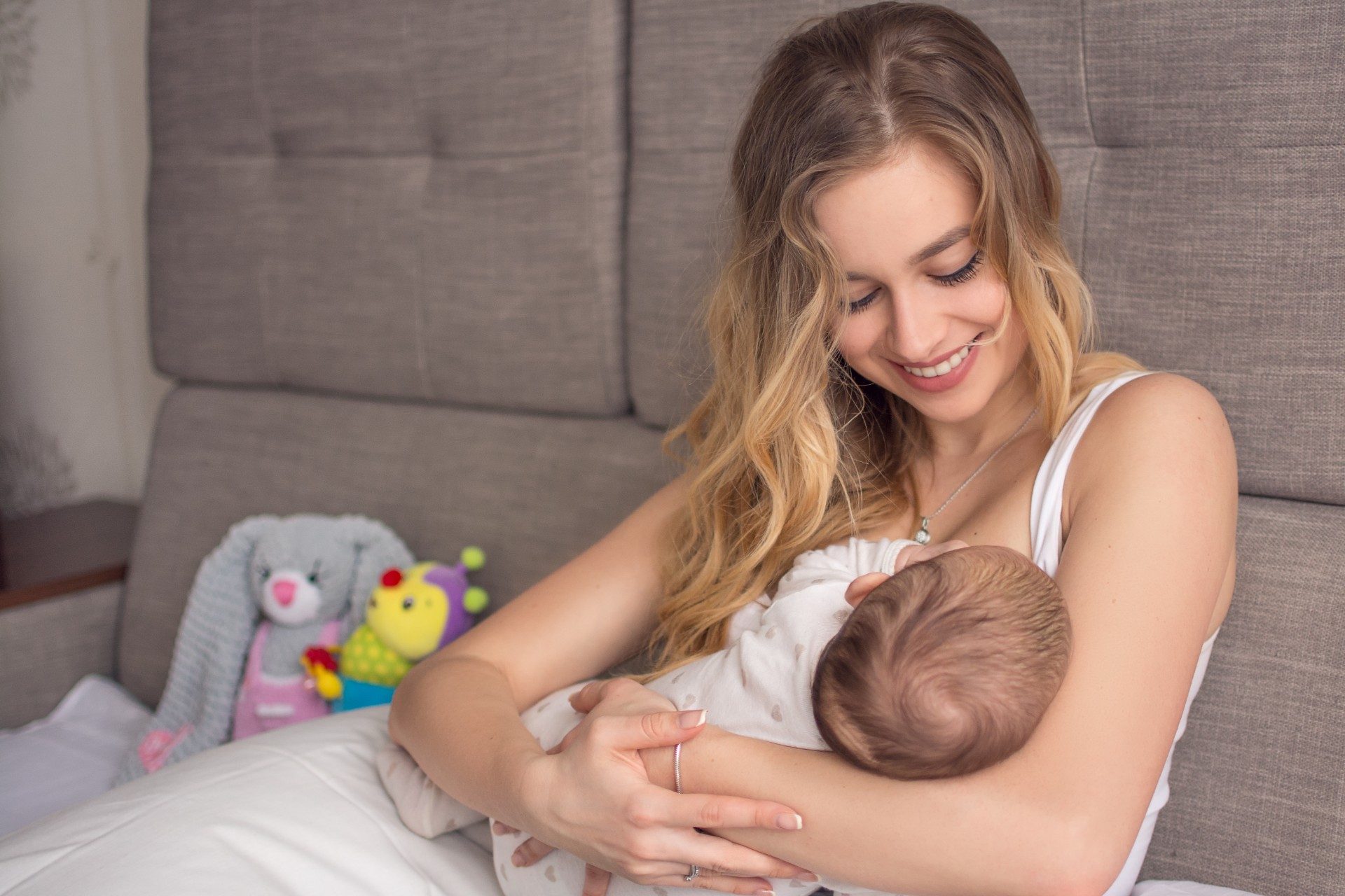Mother cradling her baby while breastfeeding