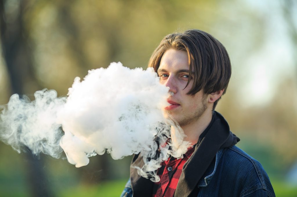 Teen vaping outside