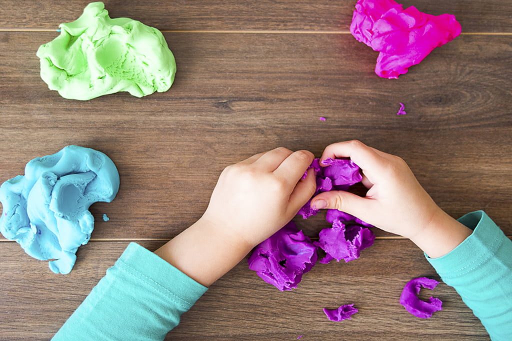 child playing with playdough