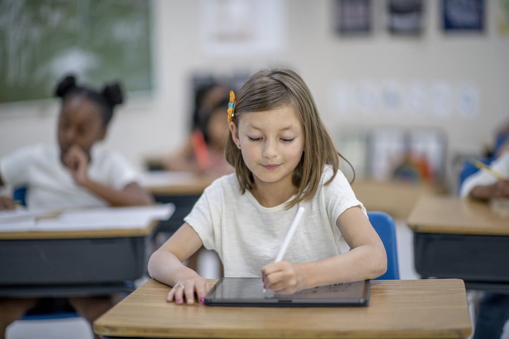 Young girl at a desk in a classroom