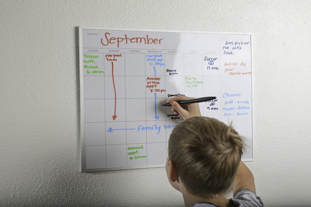 Child writing on a calendar