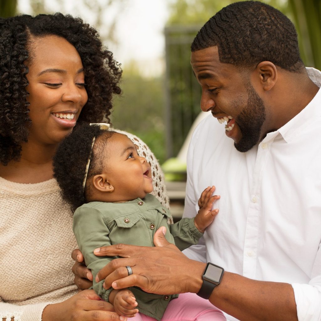 Mother and father laughing with child