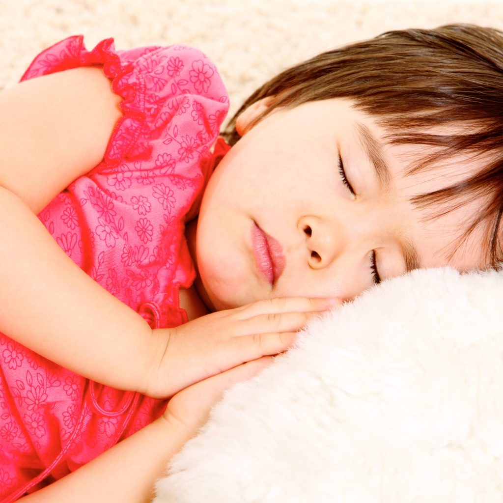 Preschool girl napping in bed