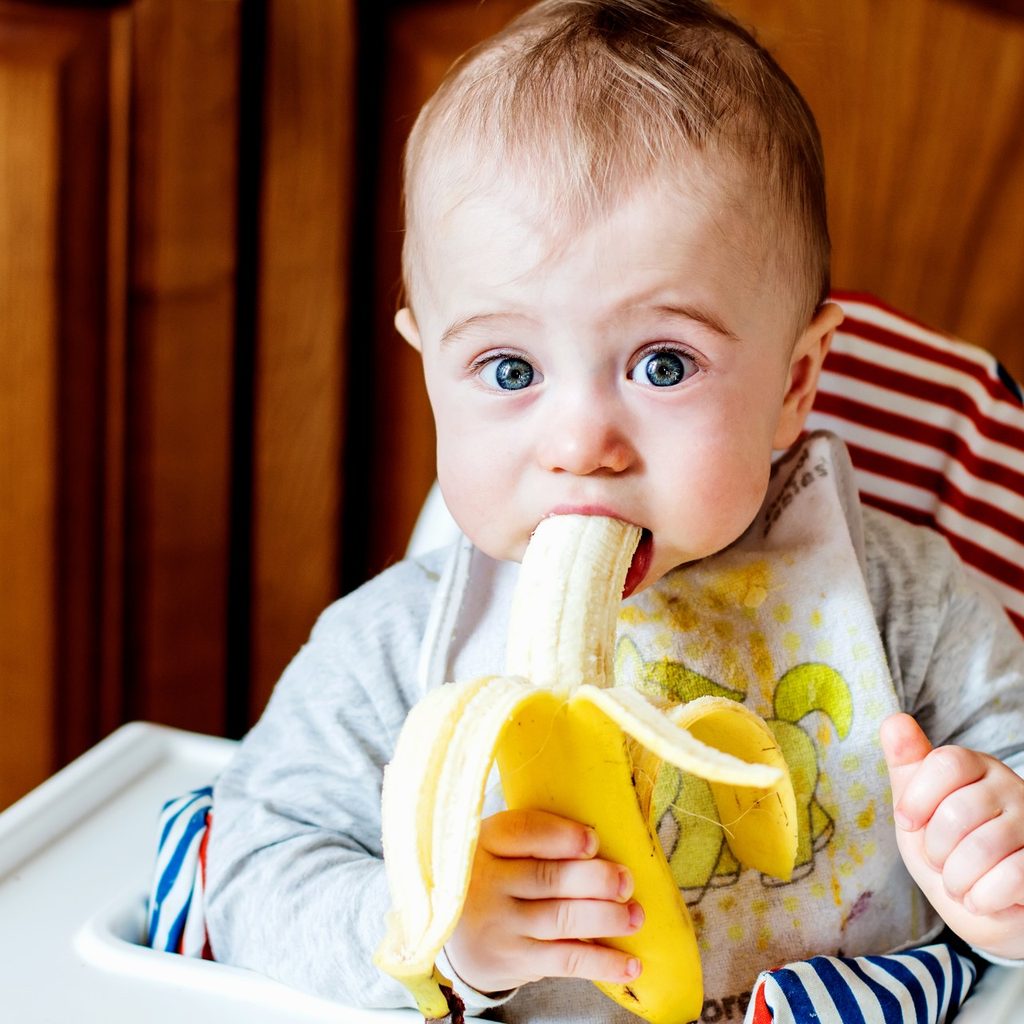 Baby eating a banana