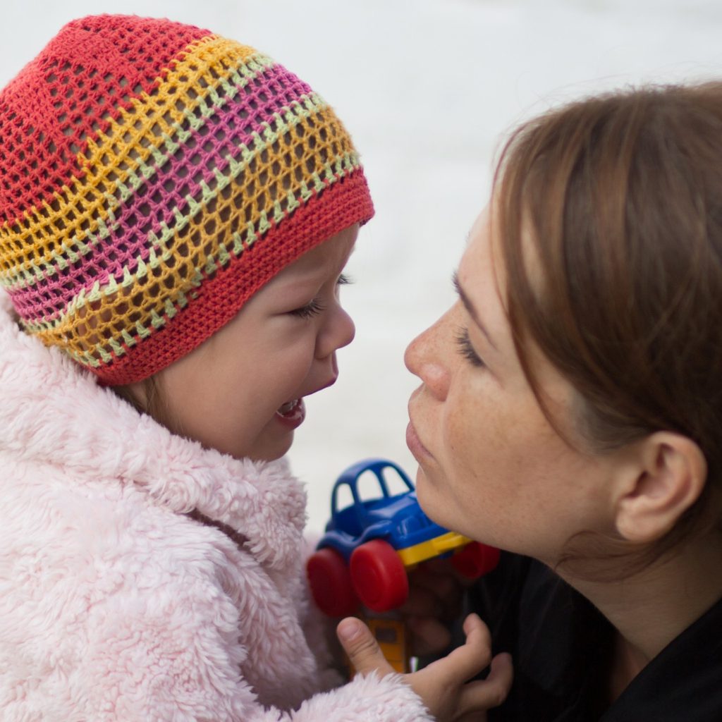 Mother consoling crying child.
