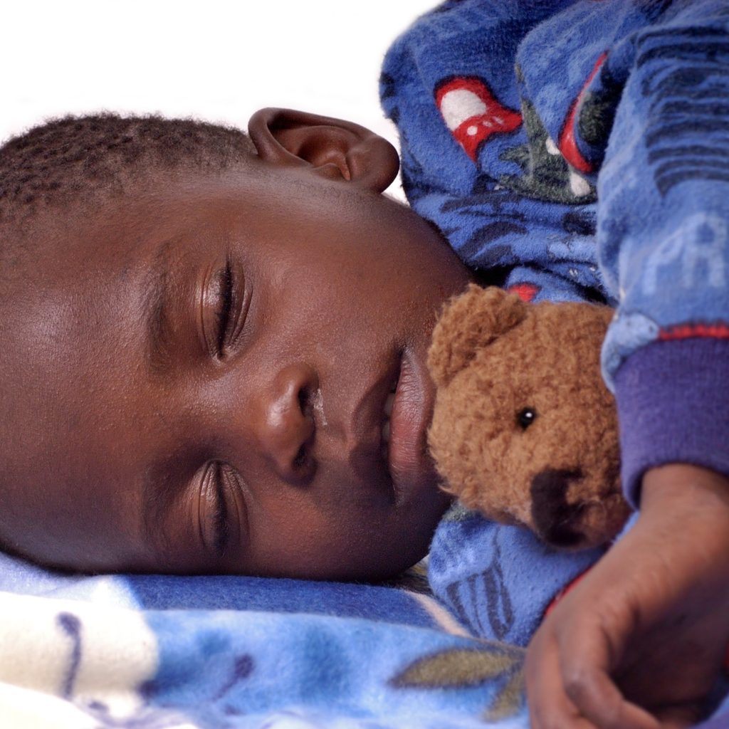 Toddler boy asleep with Teddy bear
