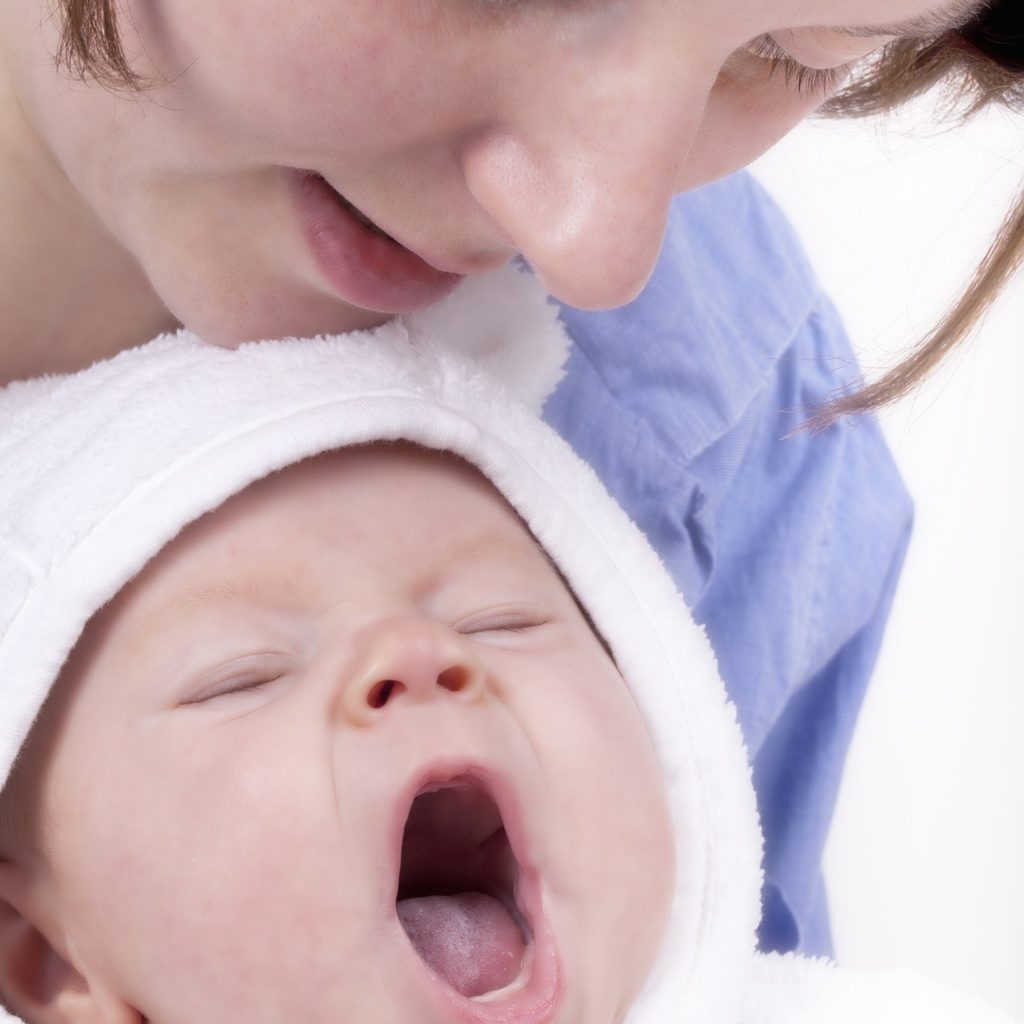 Mother sings to yawning baby