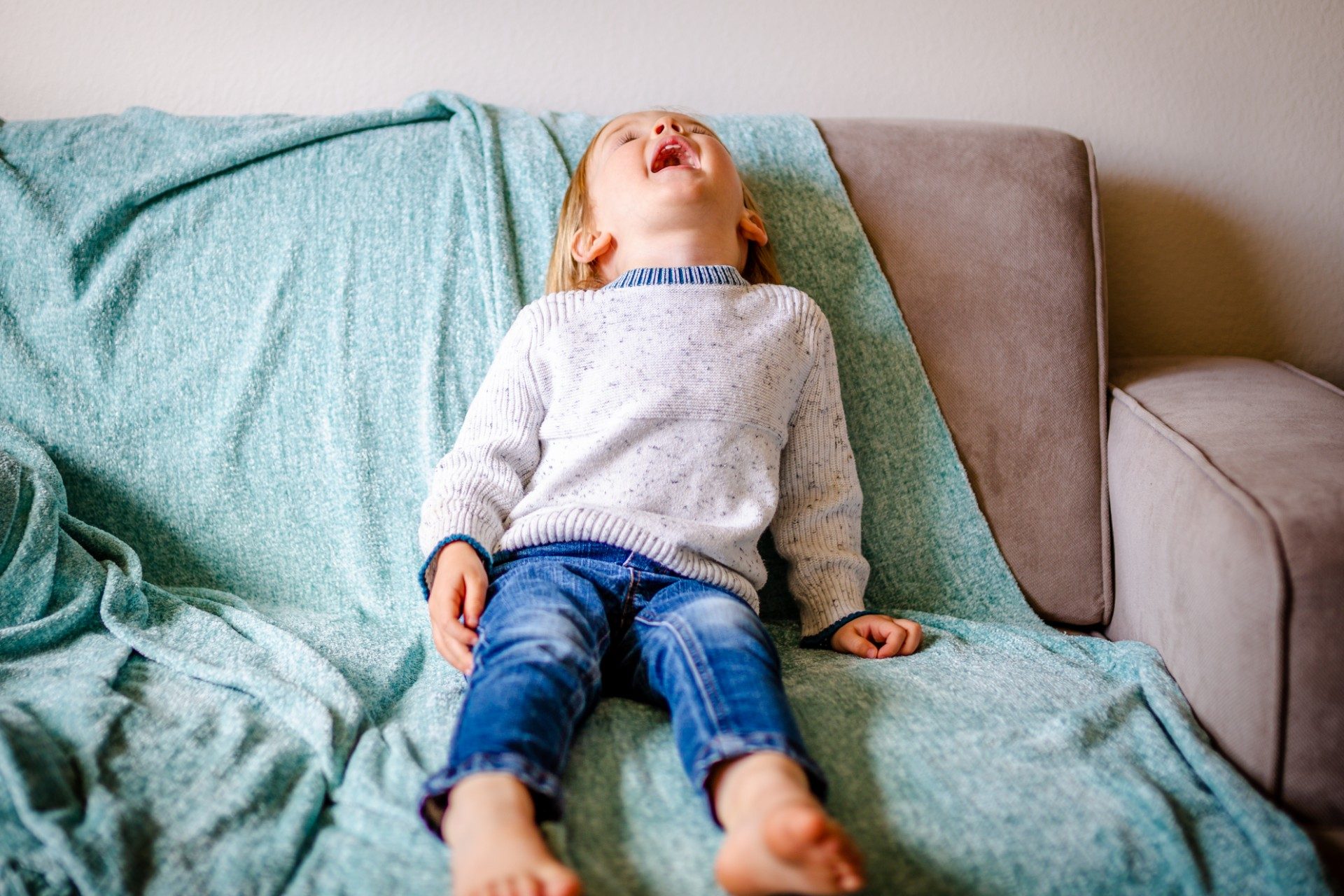 Toddler on couch having a tantrum
