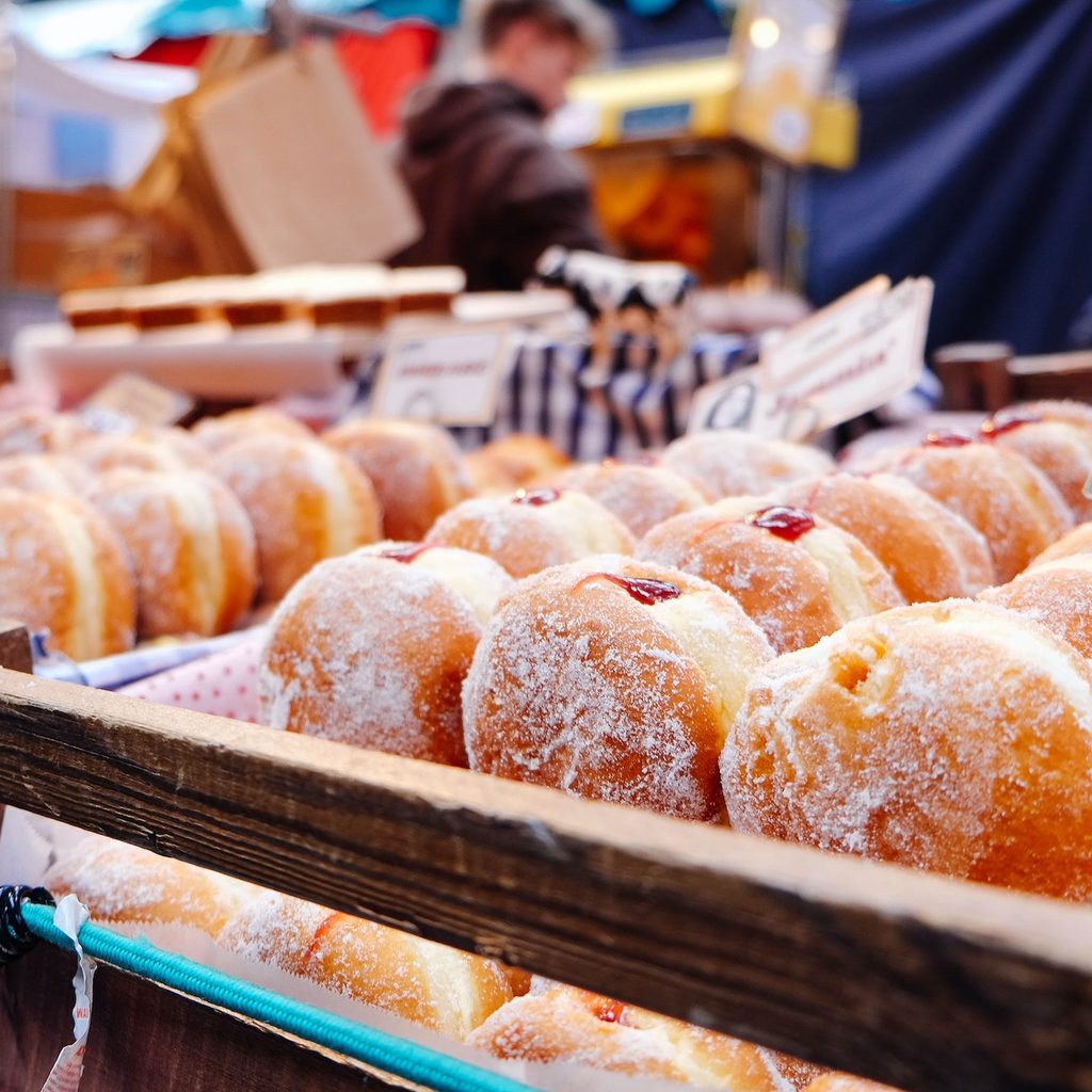 rows of jelly donuts for sale at a store