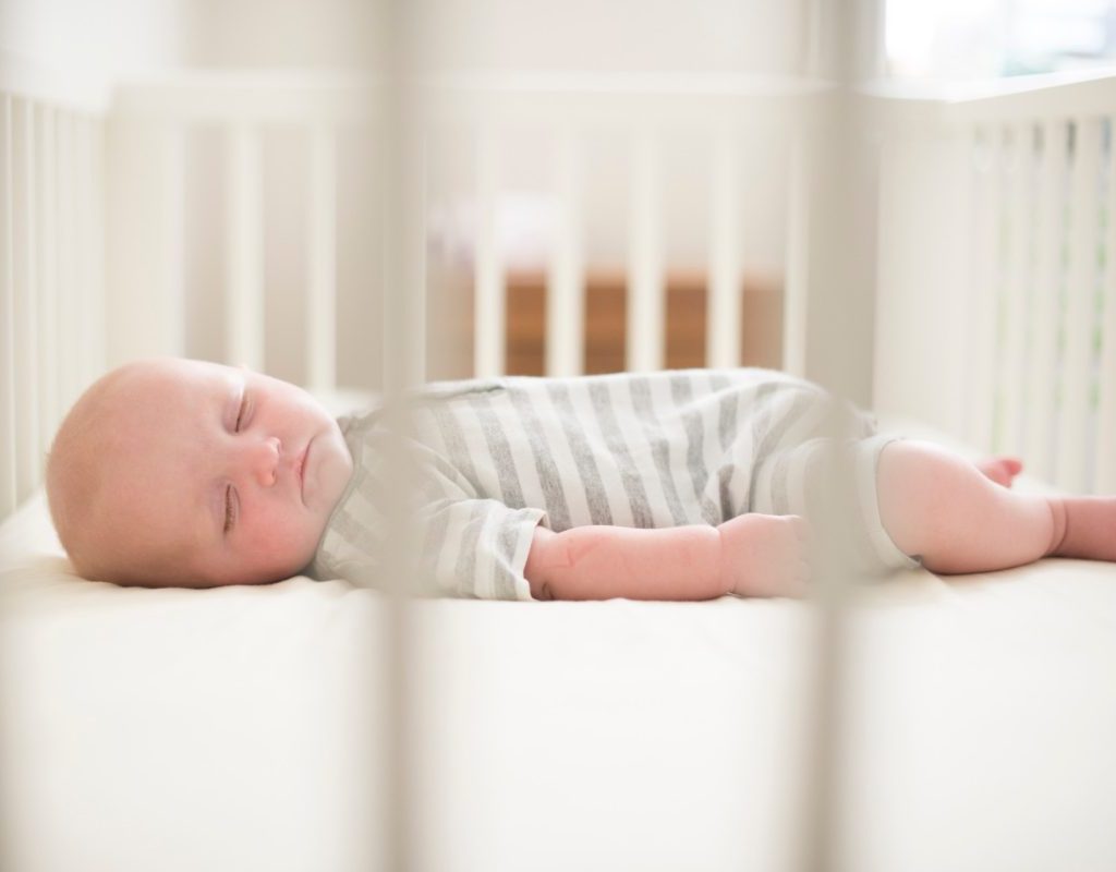 A baby sleeping in a crib