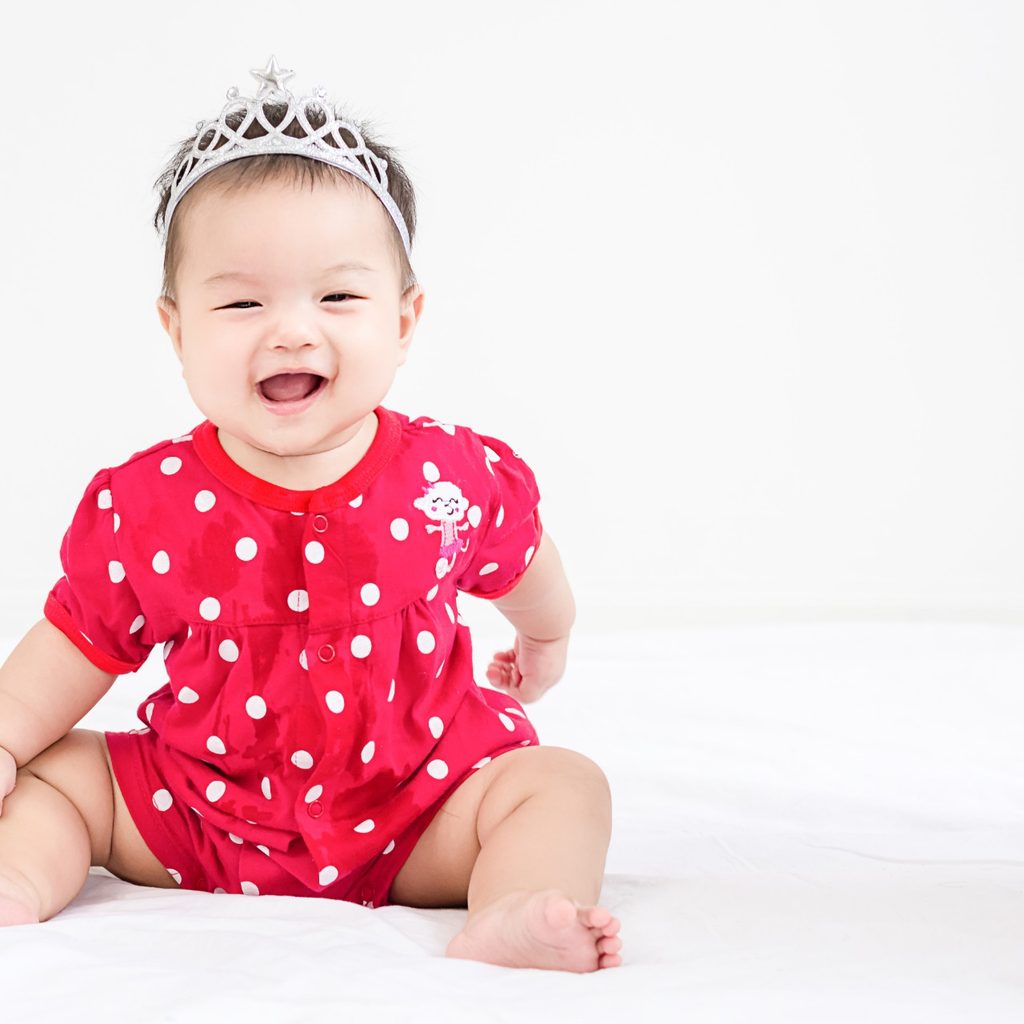 Cute baby girl in flowery shirt