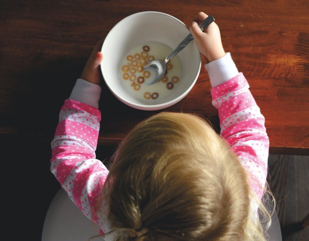 A small child eating cereal