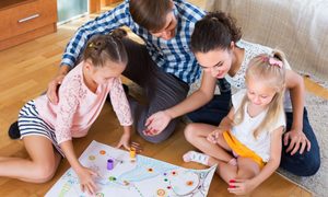 Family playing a board game at home.