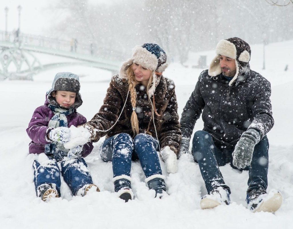 A family playing together in the snow