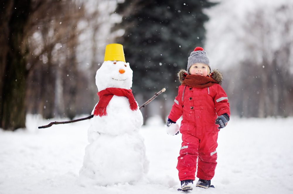 Toddler with snowman