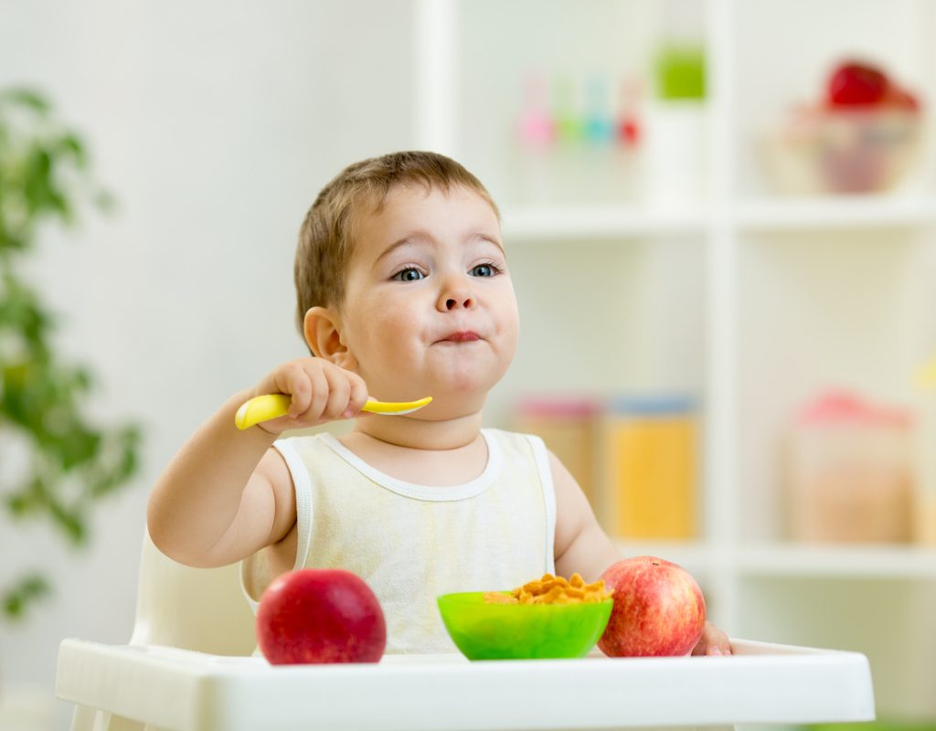 A baby eating baby food.