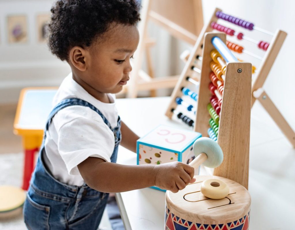 A little boy playing with table toys