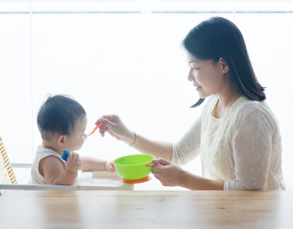 A mother feeding her baby.