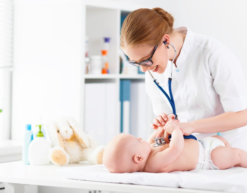 Female pediatrician examines a baby