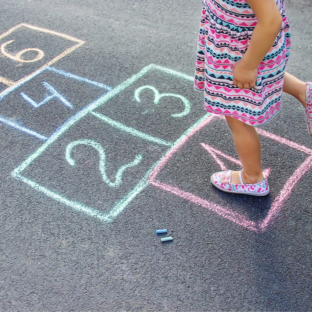 Girl playing hopscotch