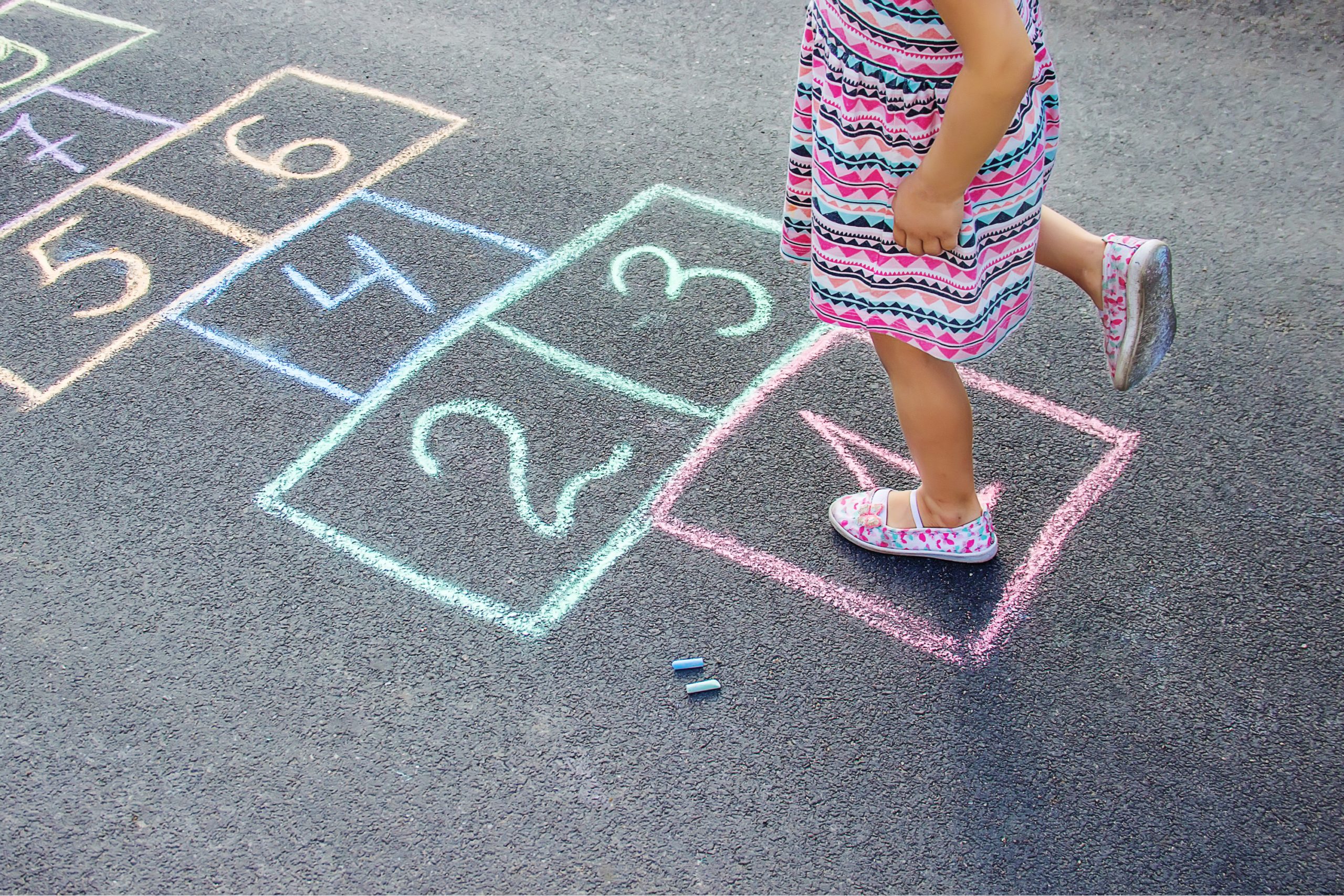 Toddler playing hopscotch