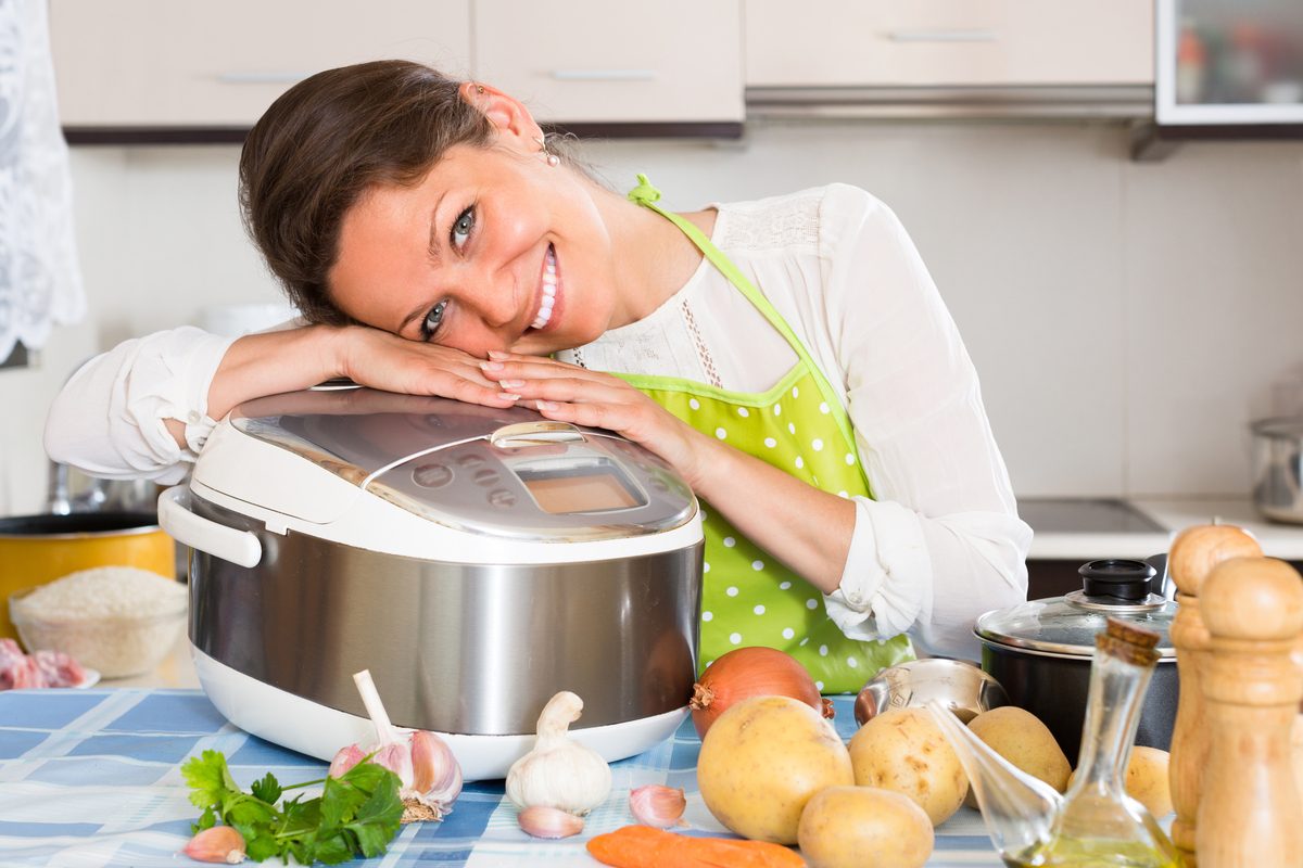 Woman hugs her slow cooker