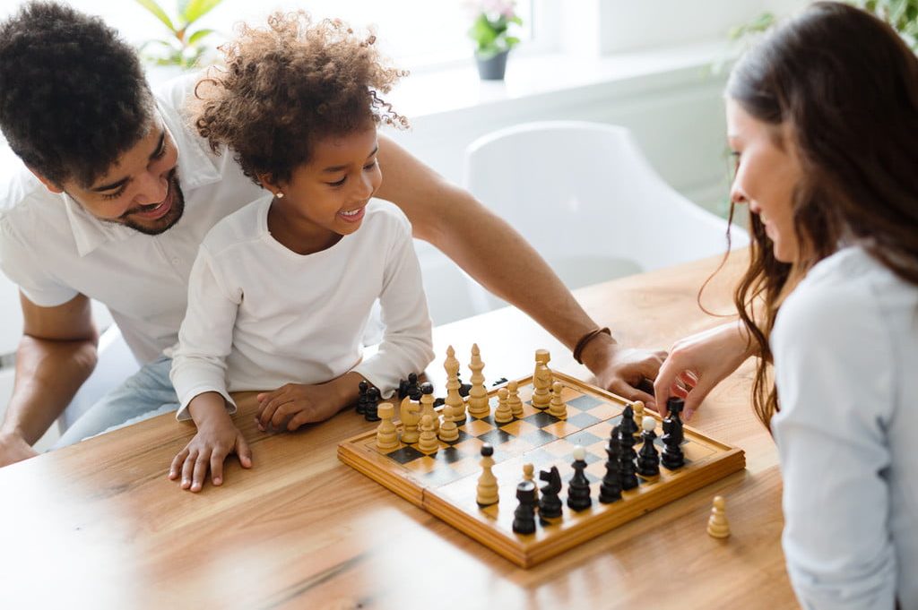family playing chess together
